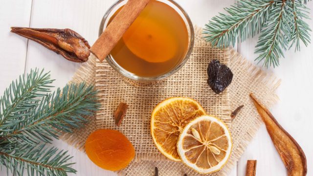 Spruce branches and traditional compote or beverage of dried fruits for Christmas