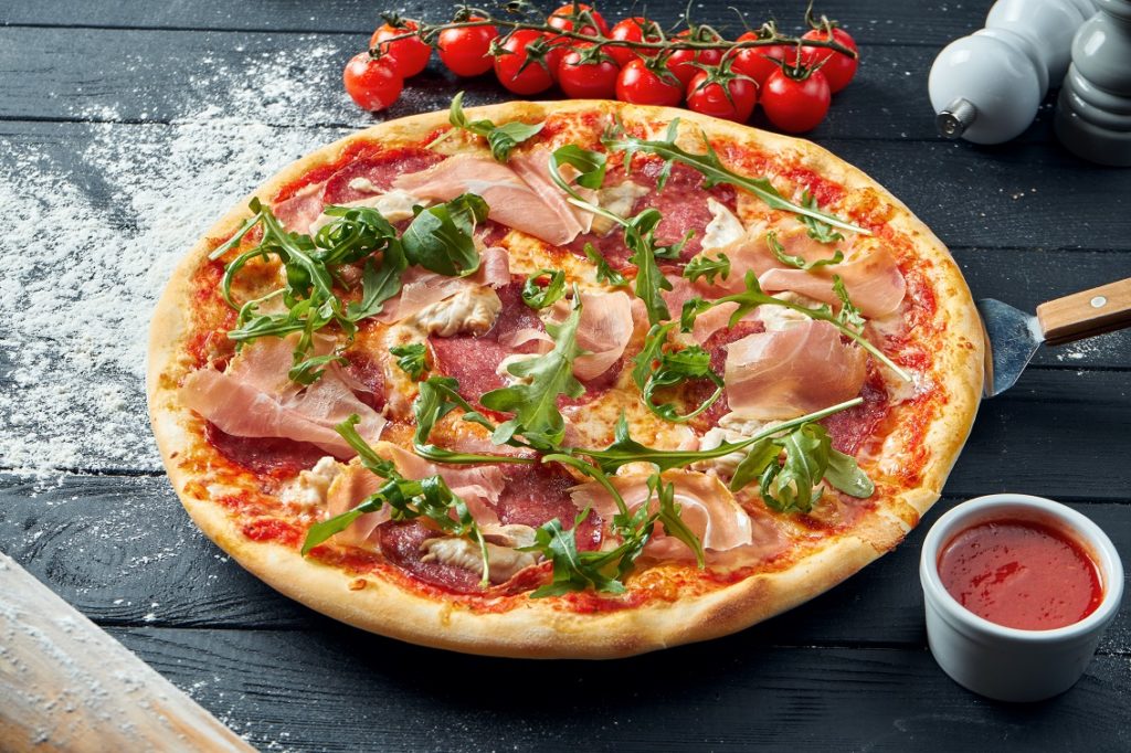 Baked,Pizza,With,Salami,,Prosciutto,And,Chicken,With,Red,Sauce